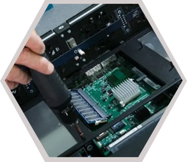 Technician performing PCB assembly inside an electronic device, showcasing EMS services from design to final board integration.