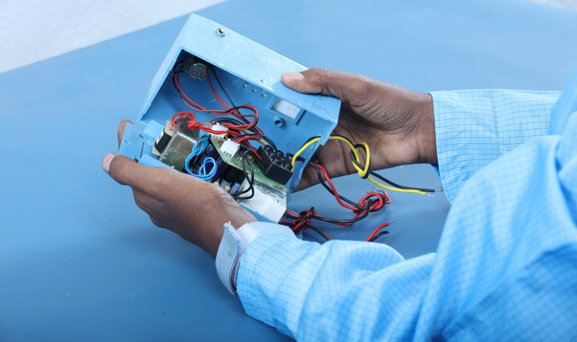 Technician assembling an electronic enclosure
