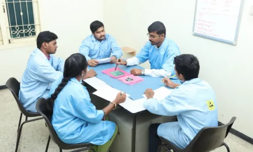 Engineers at Sanjay Technologies discussing PCB prototype designs during an electronics assembly planning session.
